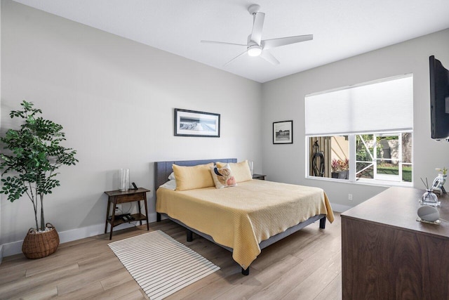 bedroom with ceiling fan and light hardwood / wood-style floors