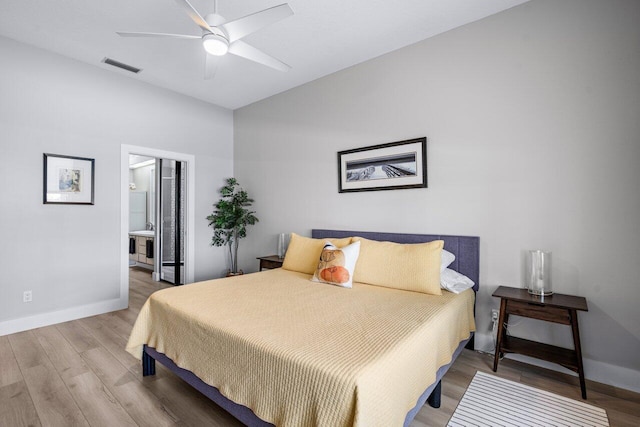 bedroom with wood-type flooring, connected bathroom, and ceiling fan