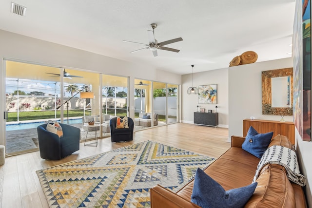 living room featuring wood-type flooring and ceiling fan