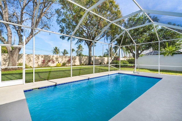 view of pool featuring a lanai, a yard, and a patio