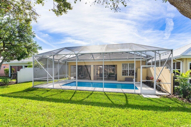 view of swimming pool with glass enclosure and a lawn