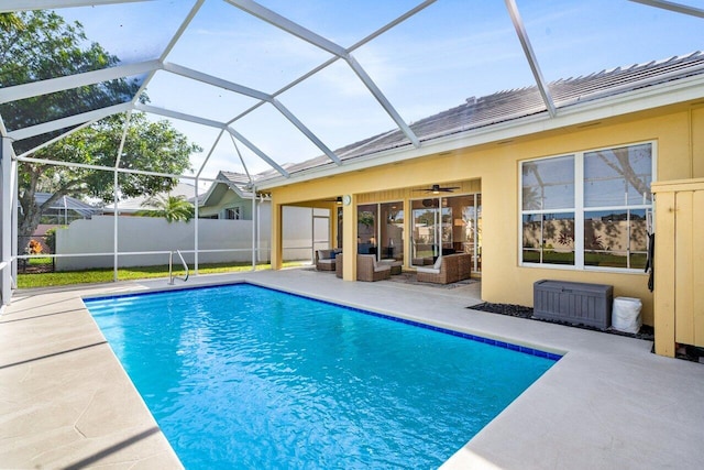 view of pool featuring ceiling fan, an outdoor living space, a lanai, and a patio area