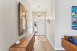 entryway featuring a notable chandelier and light wood-type flooring