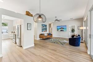 kitchen featuring ceiling fan, light brown cabinets, tasteful backsplash, light hardwood / wood-style floors, and appliances with stainless steel finishes