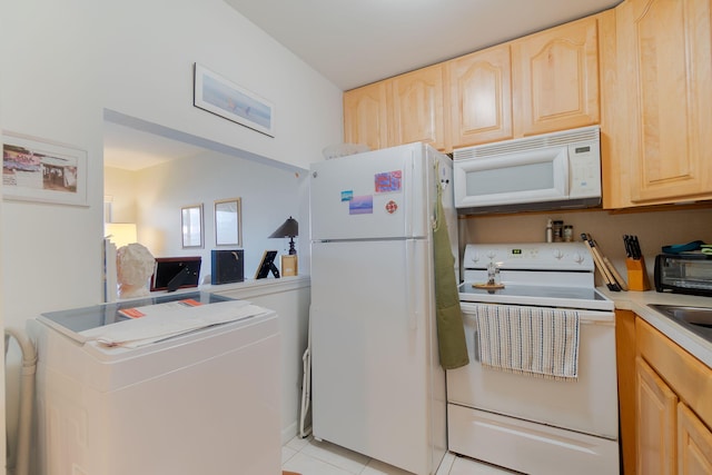 kitchen featuring light brown cabinets, light tile patterned floors, white appliances, and washer / dryer