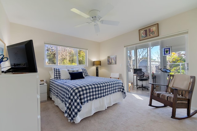 bedroom featuring multiple windows, light carpet, access to exterior, and ceiling fan