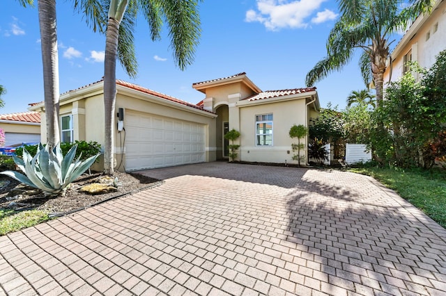 mediterranean / spanish home featuring a garage