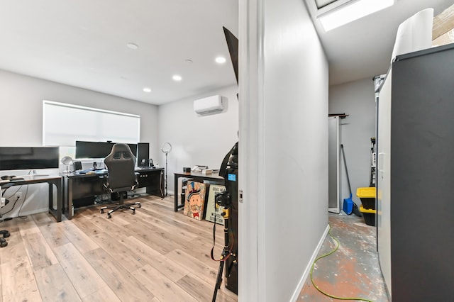 office space with a wall mounted air conditioner and light hardwood / wood-style flooring