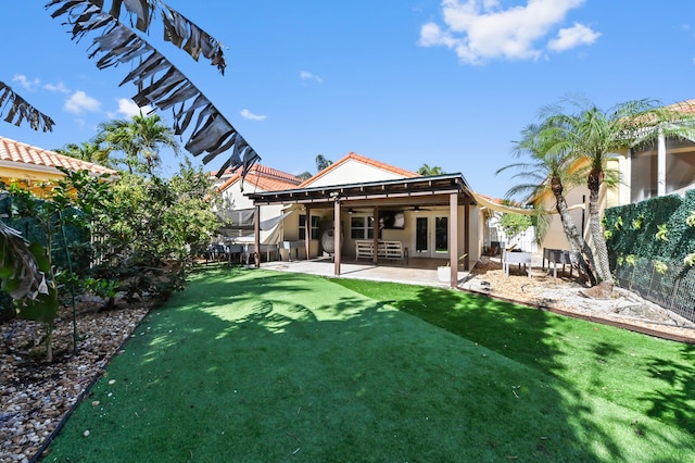 back of house with ceiling fan, a patio area, and french doors