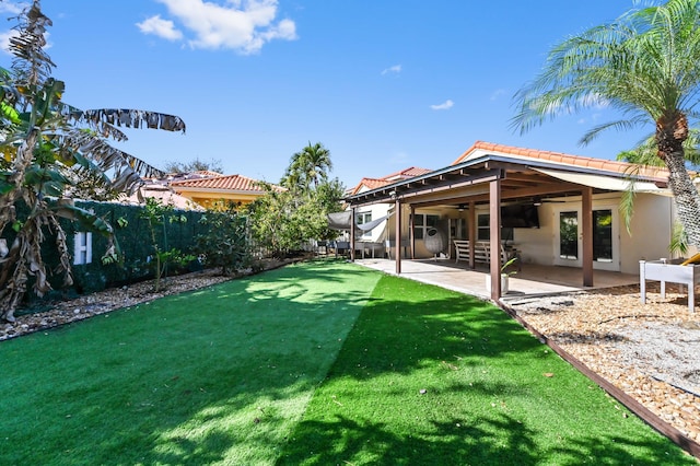 view of yard featuring ceiling fan and a patio area