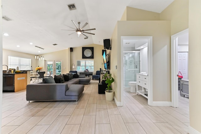 living room with ceiling fan, sink, and vaulted ceiling