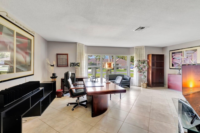 tiled home office featuring a textured ceiling