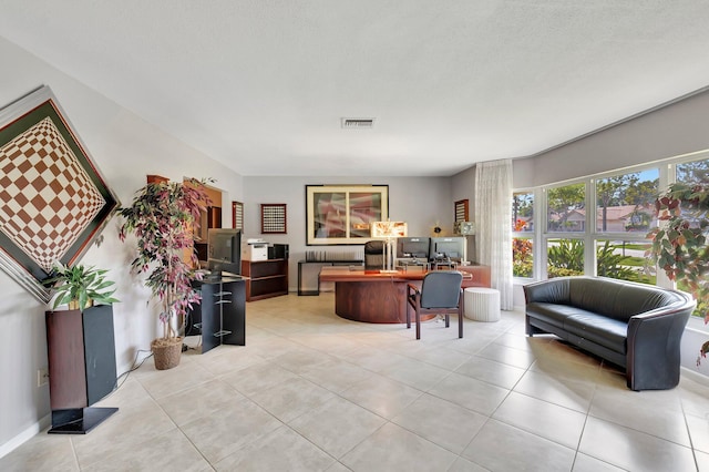 living room with light tile patterned flooring and a textured ceiling