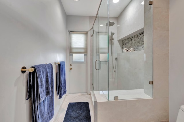 bathroom with tile patterned flooring and walk in shower