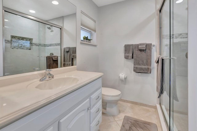 bathroom featuring tile patterned flooring, vanity, toilet, and a shower with door