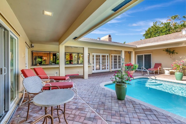 view of pool featuring french doors and a patio