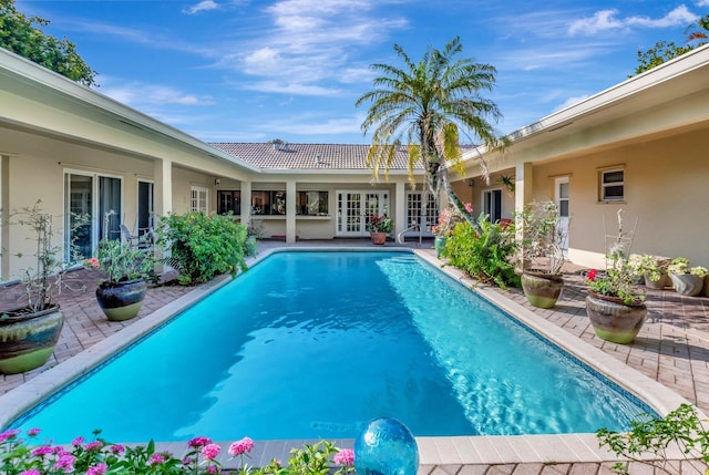 view of swimming pool featuring french doors