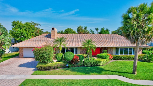 ranch-style house with a garage and a front yard