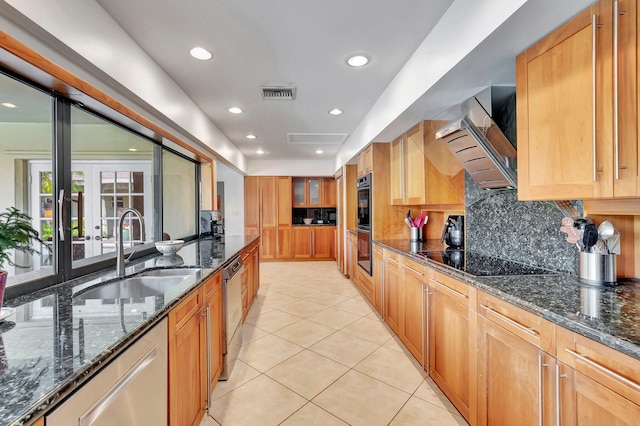 kitchen with black appliances, ventilation hood, sink, decorative backsplash, and dark stone countertops