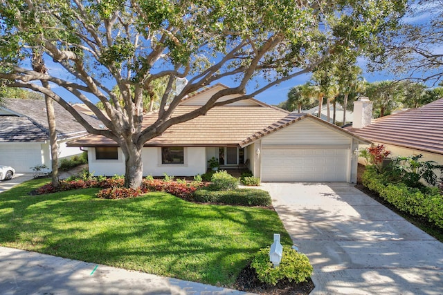 view of front of home with a garage and a front lawn