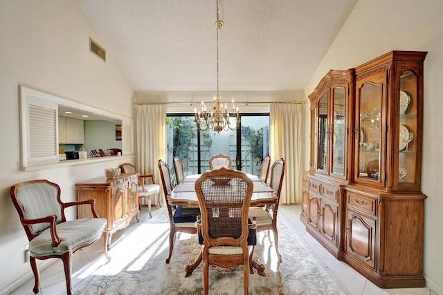 dining room featuring lofted ceiling, a textured ceiling, and a chandelier