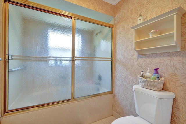 bathroom with shower / bath combination with glass door, tile patterned floors, and toilet