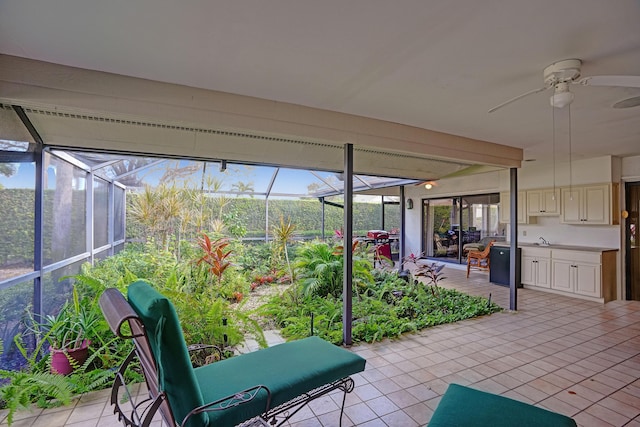 unfurnished sunroom featuring ceiling fan