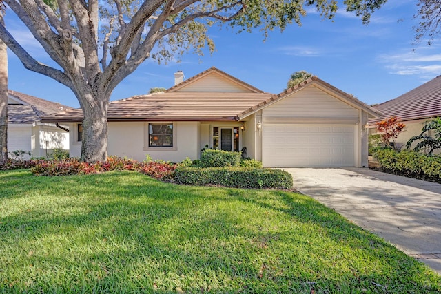 single story home featuring a garage and a front lawn