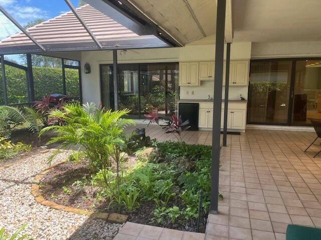 17001 Freshwind Cir, Jupiter, FL 33477 - view of patio with glass enclosure and a sink