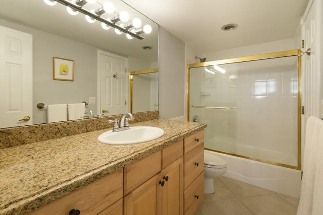 full bathroom with tile patterned flooring, vanity, toilet, and bath / shower combo with glass door