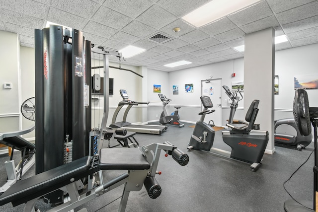 exercise room with a drop ceiling