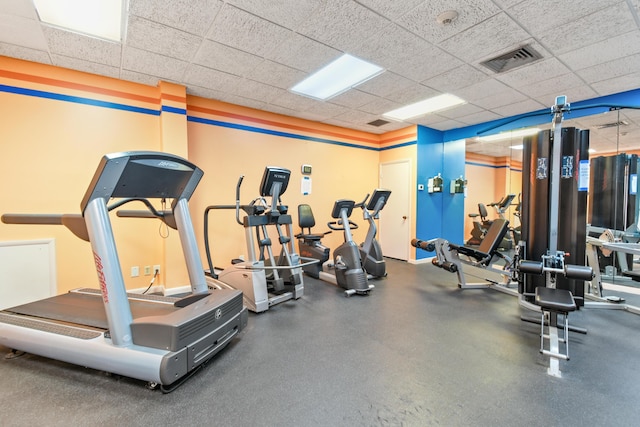 gym featuring a paneled ceiling