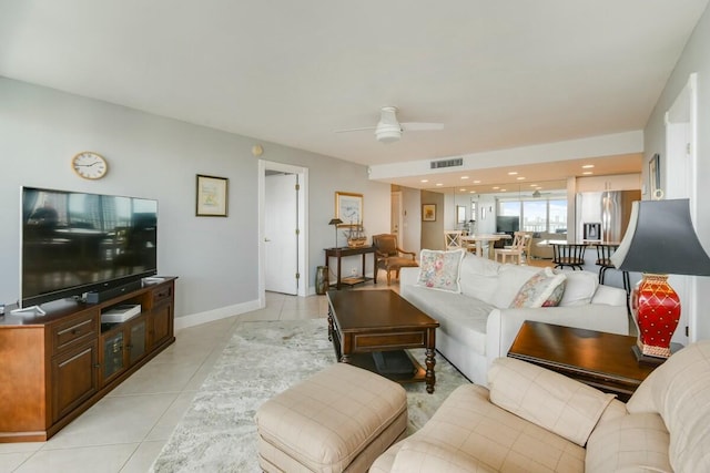 tiled living room with ceiling fan