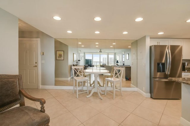 tiled dining area with ceiling fan