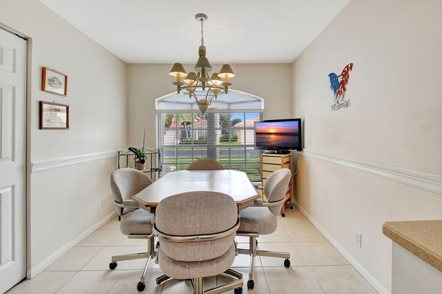 tiled dining area featuring a notable chandelier