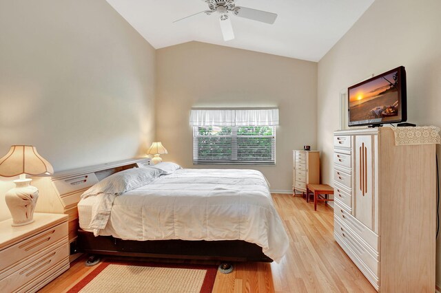 bedroom featuring light hardwood / wood-style flooring, ceiling fan, and lofted ceiling