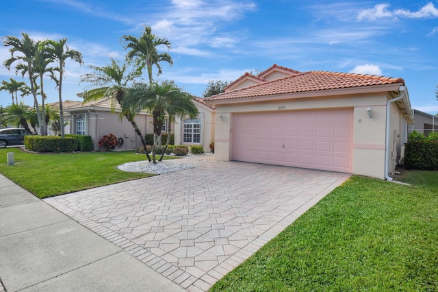 view of front of house featuring a front yard and a garage