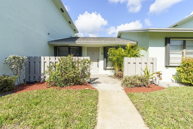 doorway to property with a yard