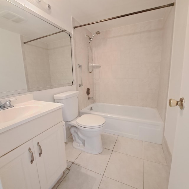 full bathroom featuring tile patterned floors, tiled shower / bath, vanity, and toilet