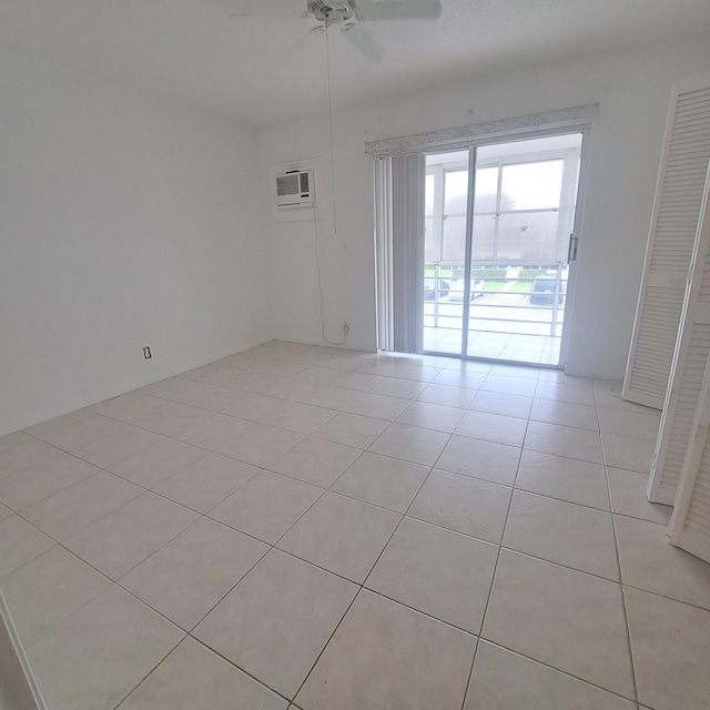 unfurnished room with ceiling fan, light tile patterned flooring, and a wall mounted AC