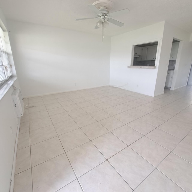 unfurnished room with ceiling fan and light tile patterned floors