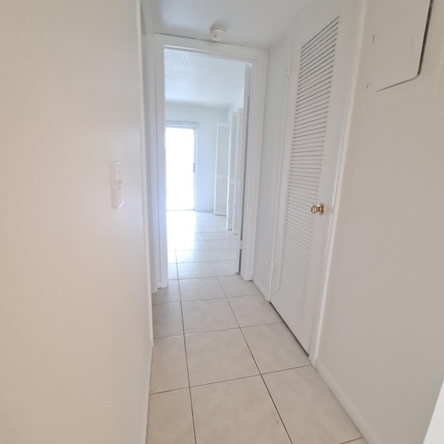 hallway featuring light tile patterned flooring