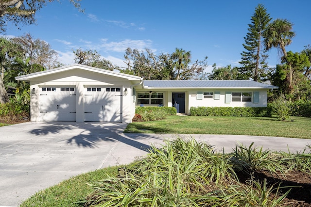 ranch-style house with a garage and a front lawn