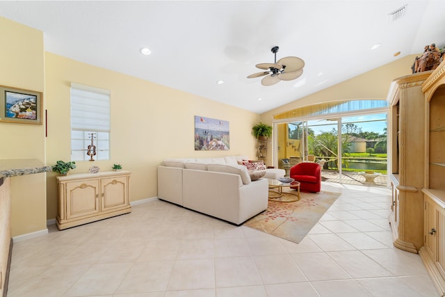 living room with light tile patterned floors, ceiling fan, and vaulted ceiling