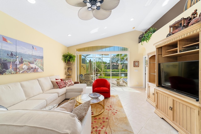 living room featuring lofted ceiling, ceiling fan, and light tile patterned floors