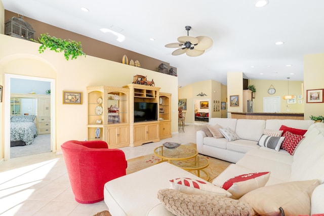 tiled living room featuring ceiling fan and lofted ceiling