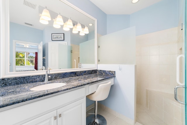 bathroom with ceiling fan, a shower with door, tile patterned flooring, and vanity