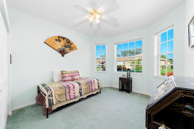 bedroom with ceiling fan and light colored carpet