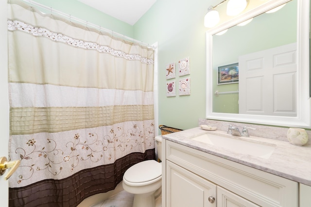 bathroom with tile patterned flooring, a shower with curtain, vanity, and toilet