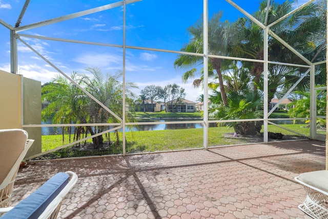 unfurnished sunroom featuring a water view